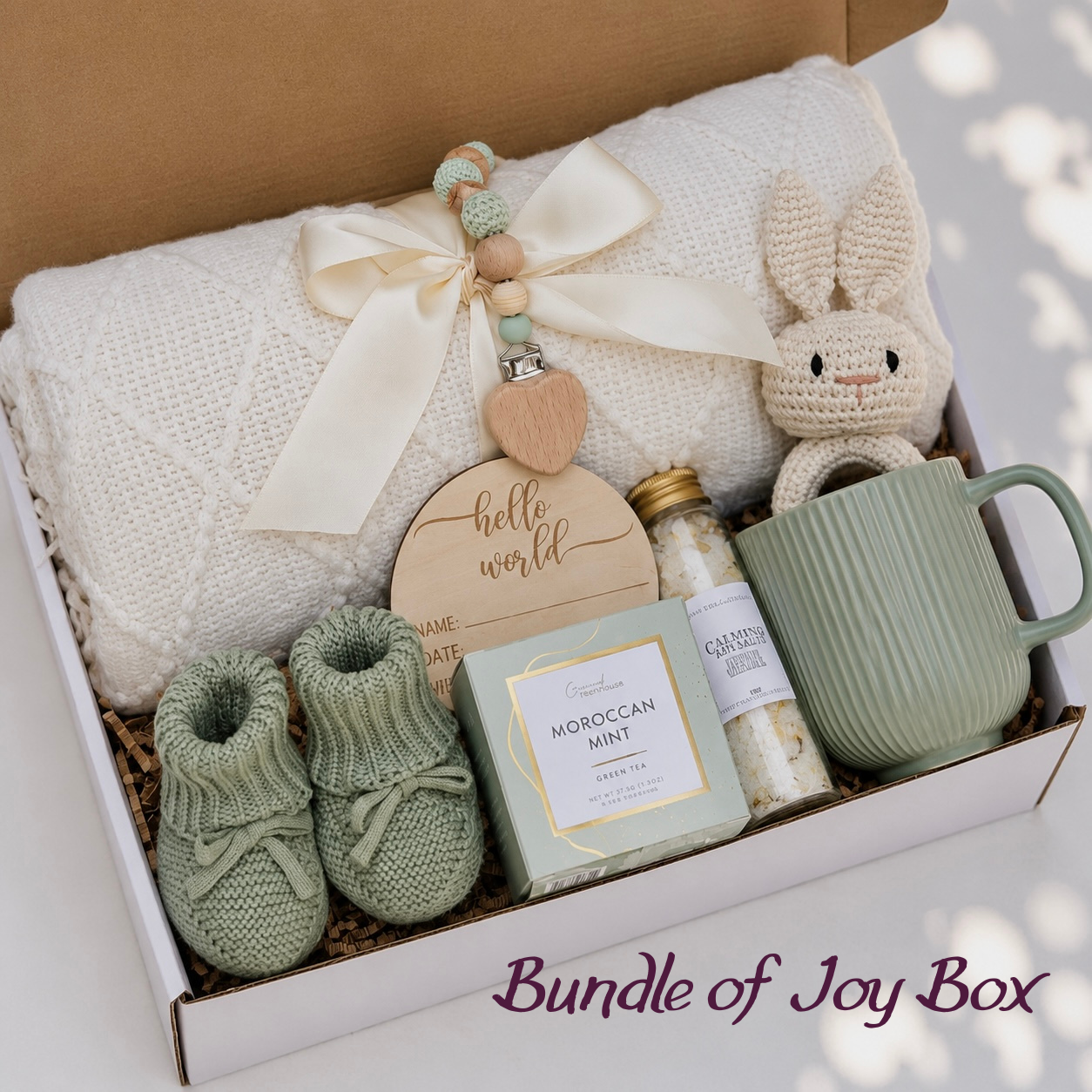 Bundle of Joy Baby Gift Box — ivory knit blanket, crochet bunny, sage green booties, hello world keepsake disc, moroccan mint tea, bath salts and mug
